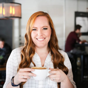 woman with red hair smiling at the camera
