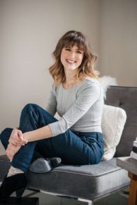 smiling woman sitting on a chair