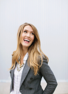 woman in a blazer laughing